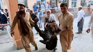 Men carry an injured person to a hospital after a blast in Jalalabad, Afghanistan(REUTERS Photo) Men carry an injured person to a hospital after a blast in Jalalabad, Afghanistan(REUTERS Photo)
