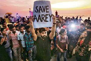 People protesting against cutting down of trees for a proposed metro car shed project at Aarey Colony in Mumbai on Sunday.(AP photo) People protesting against cutting down of trees for a proposed metro car shed project at Aarey Colony in Mumbai on Sunday.(AP photo)