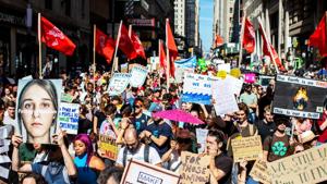 Protesters hold signs during the Global Climate Strike demonstration in New York.(Bloomberg Photo) Protesters hold signs during the Global Climate Strike demonstration in New York.(Bloomberg Photo)
