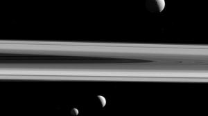 Three of Saturn's moons - Tethys, above, Enceladus, second left, and Mimas, as seen from the Cassini spacecraft.(AP Photo) Three of Saturn's moons - Tethys, above, Enceladus, second left, and Mimas, as seen from the Cassini spacecraft.(AP Photo)