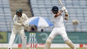 India's cricketer Cheteshwar Pujara, right, bats during the second cricket test match between India and South Africa in Pune, India.(AP) India's cricketer Cheteshwar Pujara, right, bats during the second cricket test match between India and South Africa in Pune, India.(AP)
