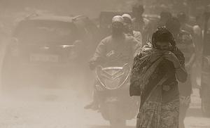 New Delhi, India - May 17, 2019: People try to cover their faces as dust blows due to traffic movement in the area around Trilokpuri road which is falling into disrepair and adding to air pollution, in New Delhi, India, on Friday, May 17, 2019. (Photo by Raj K Raj/ Hindustan Times)(Raj K Raj/HT PHOTO) New Delhi, India - May 17, 2019: People try to cover their faces as dust blows due to traffic movement in the area around Trilokpuri road which is falling into disrepair and adding to air pollution, in New Delhi, India, on Friday, May 17, 2019. (Photo by Raj K Raj/ Hindustan Times)(Raj K Raj/HT PHOTO)