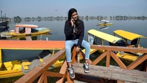 A tourist talking on her mobile phone as the Postpaid mobile services have been restored by Government, at the banks of Dal Lake in Srinagar on Monday. (ANI Photo)(ANI) A tourist talking on her mobile phone as the Postpaid mobile services have been restored by Government, at the banks of Dal Lake in Srinagar on Monday. (ANI Photo)(ANI)