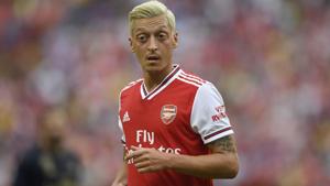 Arsenal midfielder Mesut Ozil stands on the field during the first half. Arsenal midfielder Mesut Ozil stands on the field during the first half.