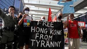 Lawmaker and activist Leung Kwok-hung holds banners and signs with protesters next to security personnel ahead of an annual policy address, after four months of anti-government protests, at the Legislative Council in Hong Kong.(REUTERS) Lawmaker and activist Leung Kwok-hung holds banners and signs with protesters next to security personnel ahead of an annual policy address, after four months of anti-government protests, at the Legislative Council in Hong Kong.(REUTERS)