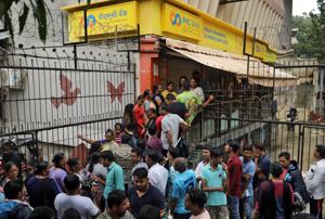 People wait outside a Punjab and Maharashtra Co-operative Bank branch to withdraw their money in Mumbai, September 25(REUTERS) People wait outside a Punjab and Maharashtra Co-operative Bank branch to withdraw their money in Mumbai, September 25(REUTERS)