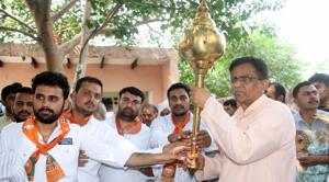 Haryana agriculture minister Om Prakash Dhankar holding a mace at a village in Badli constituency in Jhajjar district(HT Photo) Haryana agriculture minister Om Prakash Dhankar holding a mace at a village in Badli constituency in Jhajjar district(HT Photo)