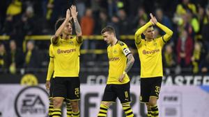 Dortmund's scorer Marco Reus, center, leaves the pitch beside Axel Witsel, left, and Julian Weigl, right, after winning the German Bundesliga soccer match between Borussia Dortmund and Borussia Moenchengladbach in Dortmund(AP) Dortmund's scorer Marco Reus, center, leaves the pitch beside Axel Witsel, left, and Julian Weigl, right, after winning the German Bundesliga soccer match between Borussia Dortmund and Borussia Moenchengladbach in Dortmund(AP)