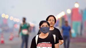 A participant seen wearing a pollution mask for protection against air pollution during the Delhi Half Marathon, near India Gate, in New Delhi, on Sunday. (Photo by Arvind Yadav/ Hindustan Times) A participant seen wearing a pollution mask for protection against air pollution during the Delhi Half Marathon, near India Gate, in New Delhi, on Sunday. (Photo by Arvind Yadav/ Hindustan Times)