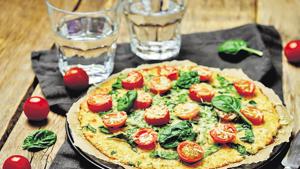 Cauliflower pizza crust with tomato and spinach.(Getty Images/iStockphoto) Cauliflower pizza crust with tomato and spinach.(Getty Images/iStockphoto)
