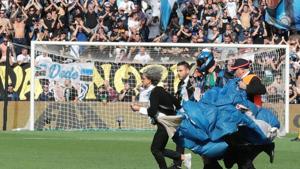 A parachutist who landed on the pitch during a Serie A match.(AP) A parachutist who landed on the pitch during a Serie A match.(AP)