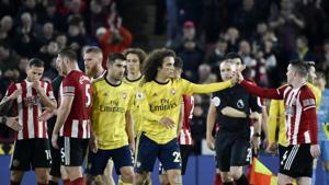 Sheffield United's and Arsenal's players react.(AP) Sheffield United's and Arsenal's players react.(AP)
