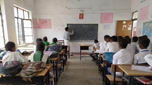 A teacher busy teaching in a classroom at government higher secondary school in Soraon, Prayagraj.(HT)