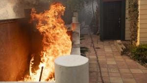 Flames burn close to an entrance of a home during the Tick fire in the Santa Clarita area of Los Angeles, Calif. on Thursday, Oct. 24, 2019(AP) Flames burn close to an entrance of a home during the Tick fire in the Santa Clarita area of Los Angeles, Calif. on Thursday, Oct. 24, 2019(AP)