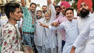 Congress supporters celebrate the results in Karnal on Thursday.(PTI)