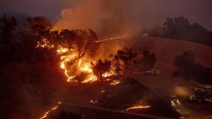 Flames from a backfire, lit by firefighters to slow the spread of the Kincade Fire, burn a hillside in unincorporated Sonoma County.(AP photo) Flames from a backfire, lit by firefighters to slow the spread of the Kincade Fire, burn a hillside in unincorporated Sonoma County.(AP photo)