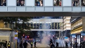 Demonstrators are shrouded in a cloud of tear gas during a protest in the Central district of Hong Kong(Bloomberg photo) Demonstrators are shrouded in a cloud of tear gas during a protest in the Central district of Hong Kong(Bloomberg photo)