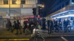 Riot police march along Des Voeux Road Central during a protest in the Sheung Wan district of Hong Kong.(Bloomberg Photo) Riot police march along Des Voeux Road Central during a protest in the Sheung Wan district of Hong Kong.(Bloomberg Photo)