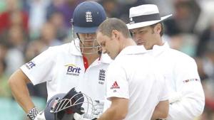 England's captain Andrew Strauss inspects his broken helmet as team-mate Alastair Cook and Australian Umpire Simon Taufel look on. England's captain Andrew Strauss inspects his broken helmet as team-mate Alastair Cook and Australian Umpire Simon Taufel look on.