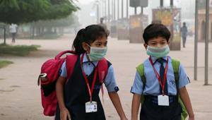 Two school students wearing a mask to protect themselves from pollution(ANI) Two school students wearing a mask to protect themselves from pollution(ANI)