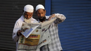 Muslims read about the verdict in a decades-old land title dispute between Muslims and Hindus in a newspaper in Ayodhya on Sunday.(AP Photo) Muslims read about the verdict in a decades-old land title dispute between Muslims and Hindus in a newspaper in Ayodhya on Sunday.(AP Photo)
