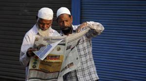 Indian Muslims read about the verdict in a decades-old land title dispute between Muslims and Hindus in a newspaper in Ayodhya on Sunday.(Photo: AP) Indian Muslims read about the verdict in a decades-old land title dispute between Muslims and Hindus in a newspaper in Ayodhya on Sunday.(Photo: AP)