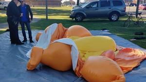 A responding officer and an unidentified man stands by a Baby Trump balloon deflated by someone at Monnish Park as people were protesting President Donald Trump's visit to an NCAA college football game between Louisiana State and Alabama playing nearby in Tuscaloosa, Ala., Saturday, Nov. 9, 2019. The towering Baby Trump protest balloon was knifed and deflated by someone unhappy with its appearance during Trump's trip to Alabama, organizers said.(AP) A responding officer and an unidentified man stands by a Baby Trump balloon deflated by someone at Monnish Park as people were protesting President Donald Trump's visit to an NCAA college football game between Louisiana State and Alabama playing nearby in Tuscaloosa, Ala., Saturday, Nov. 9, 2019. The towering Baby Trump protest balloon was knifed and deflated by someone unhappy with its appearance during Trump's trip to Alabama, organizers said.(AP)