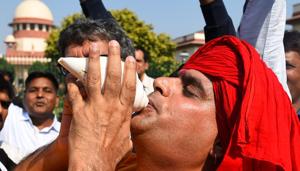 New Delhi, India - Nov. 9, 2019: A Hindu devotee blows the conch in celebration after the verdict in the Ram Janmabhoomi Babri Masjid case at Supreme Court in New Delhi, India, on Saturday, November 9, 2019. (Photo by Sanchit Khanna/ Hindustan Times)(Sanchit Khanna/HT PHOTO)