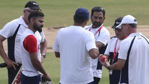 Umpires check out the new pink ball as India's captain Virat Kohli, second left, watches.(AP) Umpires check out the new pink ball as India's captain Virat Kohli, second left, watches.(AP)
