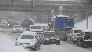 Cars navigate past a stuck car, Tuesday, Nov. 12, 2019 in Irondequoit, N.Y. Western New York is coping with its first major snowstorm of the season.(AP) Cars navigate past a stuck car, Tuesday, Nov. 12, 2019 in Irondequoit, N.Y. Western New York is coping with its first major snowstorm of the season.(AP)