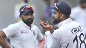 India's Mohammed Shami, left, watches captain Virat Kohli applaud teammates.(AP) India's Mohammed Shami, left, watches captain Virat Kohli applaud teammates.(AP)