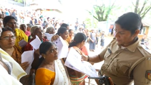 A police officer checking documents of women devotees to verify their age. Woman seen in yellow sari was later forced to retreat as she is 42, the barred age group.(Photo: Vivek R Nair/ Hindustan Times) A police officer checking documents of women devotees to verify their age. Woman seen in yellow sari was later forced to retreat as she is 42, the barred age group.(Photo: Vivek R Nair/ Hindustan Times)