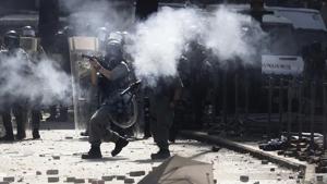 Water cannon trucks drove over bricks and nails strewn by protesters and sprayed them at close range in a bid to drive away protesters on the streets outside Hong Kong Polytechnic University.(AP Photo) Water cannon trucks drove over bricks and nails strewn by protesters and sprayed them at close range in a bid to drive away protesters on the streets outside Hong Kong Polytechnic University.(AP Photo)