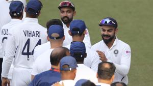 India's captain Virat Kohli, right, and Ajinkya Rahane greet members of team support staff.(AP) India's captain Virat Kohli, right, and Ajinkya Rahane greet members of team support staff.(AP)