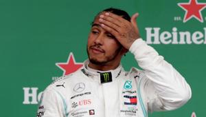 Lewis Hamilton on the podium after finishing in third place before a penalty resulted in him being demoted to seventh.(REUTERS) Lewis Hamilton on the podium after finishing in third place before a penalty resulted in him being demoted to seventh.(REUTERS)