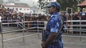 A Rapid Action Force jawan stands guard as devotees stand in queues to offer prayers at the Lord Ayyappa temple during the two-month long Mandala-Makaravillakku pilgrimage season, in Sabarimala, Monday.(PTI) A Rapid Action Force jawan stands guard as devotees stand in queues to offer prayers at the Lord Ayyappa temple during the two-month long Mandala-Makaravillakku pilgrimage season, in Sabarimala, Monday.(PTI)