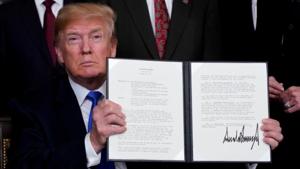 In this file picture from 2018, U.S. President Donald Trump holds his signed memorandum on intellectual property tariffs on high-tech goods from China, at the White House in Washington.(REUTERS) In this file picture from 2018, U.S. President Donald Trump holds his signed memorandum on intellectual property tariffs on high-tech goods from China, at the White House in Washington.(REUTERS)