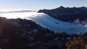 Clouds flowing down the mountains look like waterfall.(Screengrab) Clouds flowing down the mountains look like waterfall.(Screengrab)