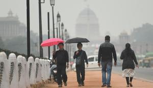 New Delhi, India - Nov. 27, 2019: Pedestrians carry umbrellas during sudden rain that brought down the temperature of the city, at Rajpath, in New Delhi, India, on Wednesday, November 27, 2019. (Photo by Raj K Raj / Hindustan Times)(Raj K Raj/HT PHOTO) New Delhi, India - Nov. 27, 2019: Pedestrians carry umbrellas during sudden rain that brought down the temperature of the city, at Rajpath, in New Delhi, India, on Wednesday, November 27, 2019. (Photo by Raj K Raj / Hindustan Times)(Raj K Raj/HT PHOTO)
