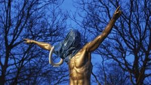 A blue plastic bag and a toilet seat hangs from the statue of the Swedish football player Zlatan Ibrahimovic in Malmo.(AP)