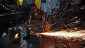 A man uses a metal grinder at a manufacturing factory in Ahmedabad. Image used for representational purpose only.(File photo: AP) A man uses a metal grinder at a manufacturing factory in Ahmedabad. Image used for representational purpose only.(File photo: AP)