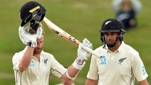New Zealand's captain Kane Williamson (L) celebrates reaching his century (100 runs) with a teammate Ross Taylor.(AFP)