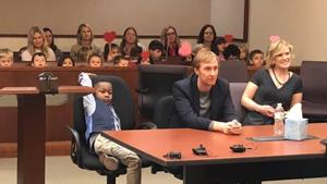 Image shows the boy, Michael, sitting with his parents.(Facebook/Kent County, Michigan) Image shows the boy, Michael, sitting with his parents.(Facebook/Kent County, Michigan)