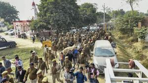 Police personnel march as family members and relatives carry the mortal remains of Unnao rape victim for burial at Unnao, Sunday, Dec. 8, 2019.(PTI) Police personnel march as family members and relatives carry the mortal remains of Unnao rape victim for burial at Unnao, Sunday, Dec. 8, 2019.(PTI)