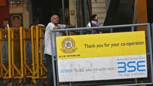 A man looks at a screen across the road displaying the Sensex on the facade of the Bombay Stock Exchange (BSE) building in Mumbai(Reuters File) A man looks at a screen across the road displaying the Sensex on the facade of the Bombay Stock Exchange (BSE) building in Mumbai(Reuters File)