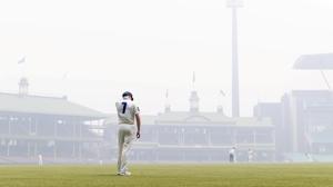 Liam Hatcher of the Blues stands in the outfield amid the smoke haze from bushfires during day 3 of the Sheffield Shield match between New South Wales and Queensland at the SCG in Sydney.(REUTERS) Liam Hatcher of the Blues stands in the outfield amid the smoke haze from bushfires during day 3 of the Sheffield Shield match between New South Wales and Queensland at the SCG in Sydney.(REUTERS)