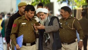 A man directs a police personal on his cell phone outside a mortuary where relatives were waiting to receive the bodies that died in the fire yesterday at a plastic factory at Anaj Mandi, at Lok Nayak Jai Prakash Narayan Hospital (LNGP), in New Delhi(Amal KS/HT PHOTO) A man directs a police personal on his cell phone outside a mortuary where relatives were waiting to receive the bodies that died in the fire yesterday at a plastic factory at Anaj Mandi, at Lok Nayak Jai Prakash Narayan Hospital (LNGP), in New Delhi(Amal KS/HT PHOTO)