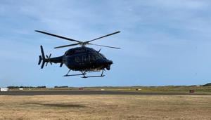 A New Zealand Police helicopter returns to Whakatane Airport after conducting a search for bodies in the aftermath of the eruption of White Island volcano, December 15, 2019.(New Zealand Police / Handout via REUTERS) A New Zealand Police helicopter returns to Whakatane Airport after conducting a search for bodies in the aftermath of the eruption of White Island volcano, December 15, 2019.(New Zealand Police / Handout via REUTERS)