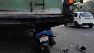 The scooter got stuck beneath the bus after crashing into it from the rear in Sector 29 on Sunday morning.(HT PHOTO)