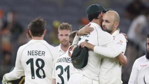 Australian bowlers Mitchell Starc and Nathan Lyon hug after winning their cricket test against New Zealand in Perth.(AP) Australian bowlers Mitchell Starc and Nathan Lyon hug after winning their cricket test against New Zealand in Perth.(AP)